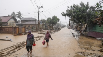 Warga berjalan di desa yang luluh lantak pascabanjir di Desa Bundar, Karang Baru, Kabupaten Aceh Tamiang, Aceh, Selasa (9/12/2025). [ANTARA FOTO/Erlangga Bregas Prakoso/mrh/foc]