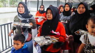 Sejumlah orang tua memberikan Makan Bergizi Gratis (MBG) kepada anak-anak dalam kegiatan Cegah Stunting (Centing) yang digelar di Jimmy Hantu Foundation, Kecamatan Tamansari, Kabupaten Bogor, Jawa Barat, Selasa (16/12/2025). [Suara.com/Alfian Winanto]