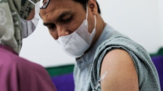 Dokter menyuntikkan vaksin influenza Flubio kepada pasien di Klinik Pratama Dermaga Raya, Jakarta, Rabu (7/1/2026). [Suara.com/Alfian Winanto]