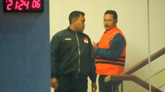 Wali Kota Madiun Maidi (tengah) dibawa ke mobil tahanan usai menjalani pemeriksaan di Gedung Merah Putih KPK, Jakarta, Selasa (20/1/2026). [Suara.com/Alfian Winanto]
