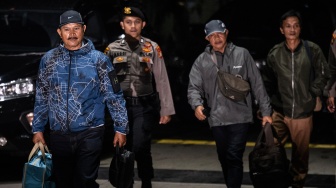 Wali Kota Madiun Maidi (kiri) bersama Kepala Dinas PUPR Kota Madiun Thariq Megah (kanan) dikawal petugas setibanya di Gedung Merah Putih KPK, Jakarta, Senin (19/1/2026). [ANTARA FOTO/Bayu Pratama S./rwa]