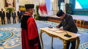 Presiden Prabowo Subianto (kanan) menandatangani berita acara pelantikan Hakim Mahkamah Konstitusi (MK) disaksikan Hakim MK Adies Kadir (kiri) saat pembacaan sumpah jabatan Hakim MK dan Wakil Menteri Keuangan di Istana Negara, Jakarta, Kamis (5/2/2026). [ANTARA FOTO/Galih Pradipta/foc]