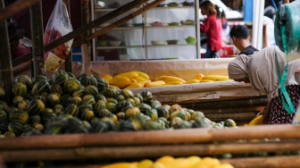Pedagang menata buah timun suri dan Blewah yang dijual di Pasar Induk Kramat Jati, Jakarta, Jumat (6/2/2026). [Suara.com/Alfian Winanto]