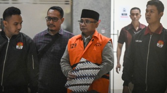 Tersangka kasus dugaan korupsi kuota haji dan penyelenggaraan ibadah haji Yaqut Cholil Qoumas (tengah) mengenakan rompi tahanan usai menjalani pemeriksaan di Gedung Merah Putih KPK, Jakarta, Kamis (12/3/2026).[ANTARA FOTO/Sulthony Hasanuddin/wsj]