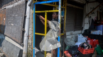 Warga terdampak relokasi membongkar pintu rumahnya di Kamal, Kalideres, Jakarta, Selasa (31/3/2026). [ANTARA FOTO/Putra M. Akbar/tom]