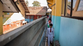 Sejumlah murid berjalan di dekat pagar yang dipasang oleh pihak ahli waris di SDN Bunisari, Ngamprah, Kabupaten Bandung Barat, Jawa Barat, Senin (13/4/2026). [ANTARA FOTO/Abdan Syakura/wsj]
