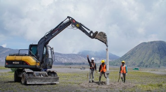 Pekerja memasang patok beton menggunakan alat berat saat acara groundbreaking penataan Jalur Lingkar Kaldera Tengger (JLKT) di kawasan Taman Nasional Bromo Tengger Semeru (TNBTS), Kabupaten Probolinggo, Jawa Timur, Senin (13/4/2026). [ANTARA FOTO/Irfan Sumanjaya/wsj]
