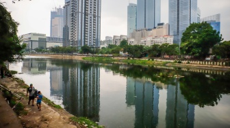 Warga beraktivitas di Waduk Melati, Jakarta, Kamis (14/5/2026). [Suara.com/Alfian Winanto]