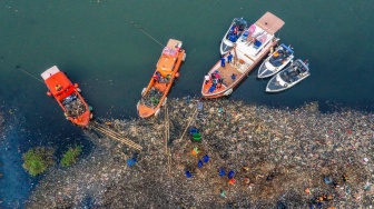 Petugas mengangkut sampah yang mengendap di perairan laut Jakarta, Rabu (3/6/2026). [ANTARA FOTO/Sulthony Hasanuddin/nz]