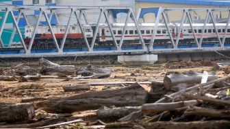 Kereta api melintas di jembatan dekat sisa material banjir bandang yang masih menutupi lapangan sepak bola Brandon di Lapai, Padang, Sumatera Barat, Rabu (10/6/2026). [ANTARA FOTO/Fitra Yogi/bar]