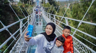 Wisatawan berswafoto saat mengunjungi Jembatan Kaca Seruni Point Bromo di Kabupaten Probolinggo, Jawa Timur, Sabtu (27/6/2026). [ANTARA FOTO/Irfan Sumanjaya/hma]
