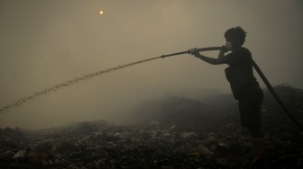Petugas pemadam kebakaran berusaha memadamkan api di Tempat Pembuangan Akhir (TPA) Jatiwaringin, Kabupaten Tangerang, Banten, Rabu (1/7/2026). [ANTARA FOTO/Putra M. Akbar/YU]