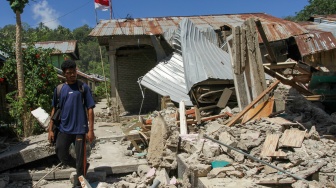 Warga melintas di samping bangunan rumah yang roboh akibat gempa bumi magnitudo 7,7 di Pulau Palue, Kabupaten Sikka, NTT, Rabu (19/8/2026). [ANTARA FOTO/Mega Tokan/app/nym]