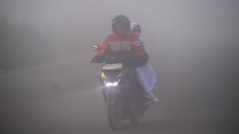 Pengendara melintas di jalan lingkar selatan Palembang-Banyuasin yang tertutup kabut asap di Kabupaten Banyuasin, Sumatera Selatan, Rabu (2/9/2026). [ANTARA FOTO/Nova Wahyudi/nz]