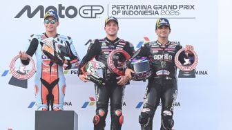 Pembalap Aprilia Racing Marco Bezzecchi (tengah) diapit rekan setimnya Jorge Martin (kanan) dan rivalnya Raul Fernandez (kiri) berfoto dengan piala mereka usai memenangi balapan MotoGP Pertamina Grand Prix of Indonesia 2026 di Sirkuit Internasional Pertamina Mandalika, KEK Mandalika, Lombok Tengah, NTB, Minggu (11/10/2026). [ANTARA FOTO/Fikri Yusuf/app/bar]