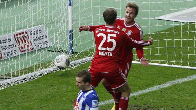 Mario Goetze (kanan) dan Thomas Mueller usai membobol gawang Hertha Berlin di liga Jerman, di Berlin, Selasa (25/3). [Reuters/Fabrizio Bensch]