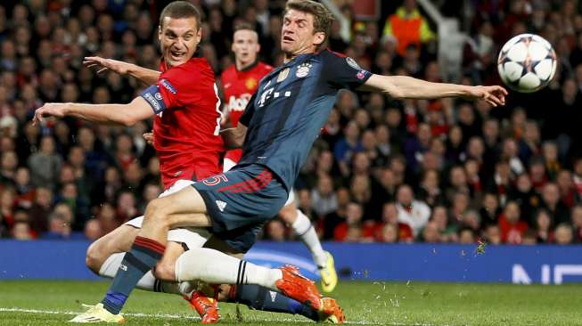 Pemain Manchester United Nemanja Vidic bertabrakan dengan pemain Bayern Muenchen Thomas Mueller dalam laga leg pertama babak 8 besar Liga Champions di kandang MU, Old Trafford, Manchester, [1/4]. [Reuters/Stefan Wermuth]