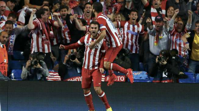 Pemain Atletico Madrid's Adrian Lopez (kiri) merayakan golnya ke gawang Chelsea dengan rekan setimnya Arda Turan guna membuat kedudukan menjadi imbang 1-1 pada menit ke-44 di Stamford Bridge.(Reuters/Stefan Wermuth) 