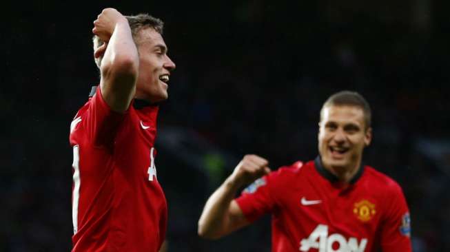 Striker berusia 18 tahun James Wilson (kiri) merayakan golnya ke gawang Hull City bersama Nemanja Vidic di Old Trafford. (Reuters/Darren Staples) 