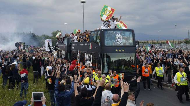 Para pemain Juventus dan staff langsung menaiki bus atap terbuka setelah mereka mengalahkan Cagliari merayakan keberhasilan mereka mempertahankan Scudetto (REUTERS/Alessandro Garofalo)