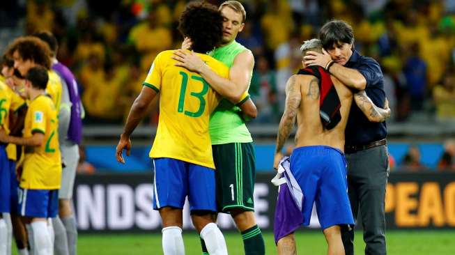 Joachim Loew (kanan) dan Manuel Neuer berpelukan dengan Daniel Alves dan Dante, usai laga Brasil vs Jerman, Selasa (8/7/2014). [Reuters/Kai Pfaffenbach]