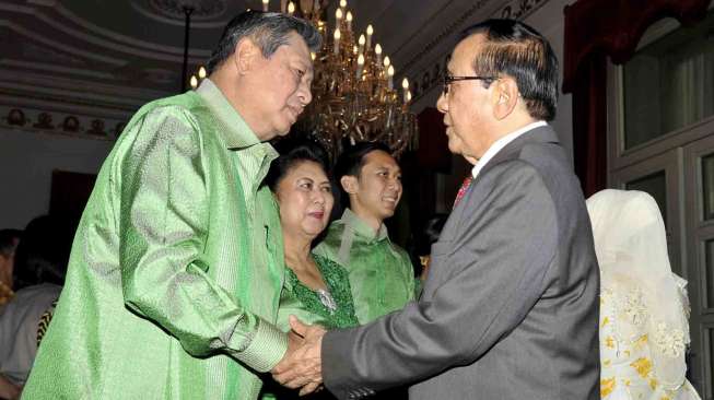 Presiden Susilo Bambang Yudhoyono (kiri) menyalami Akbar Tanjung (kanan) pada acara open house Idul Fitri  1435 H di Istana Negara, Jakarta, Senin (28/7). [Antara/Andika Wahyu]