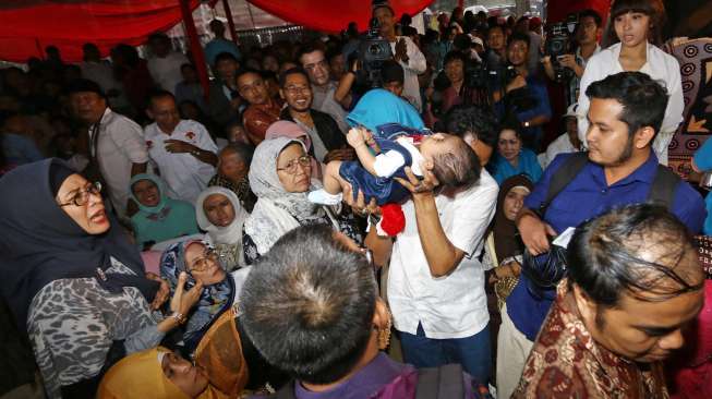Seorang dan bayi jatuh pingsan saat halal bi halal di Rumah Polonia Jakarta, Minggu (3/8). [Suara.com/Kurniawan Mas'ud]