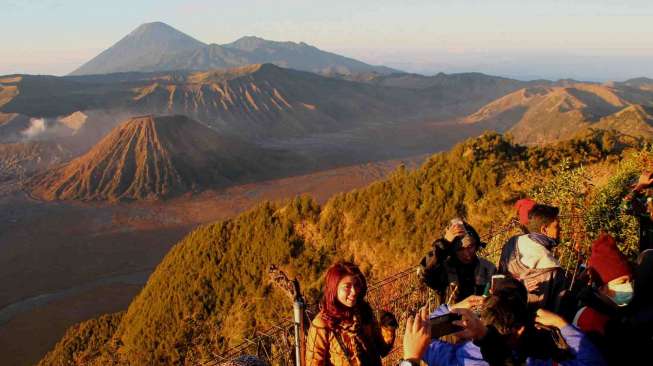 Sejumlah wisatawan mengabadikan momen matahari terbit di Taman Nasional Bromo Tengger Semeru (TNBTS) dari puncak Penanjakan I, Kecamatan Tosari, Kabupaten Pasuruan, Jawa Timur, Sabtu (12/9). [Antara/Suryanto]