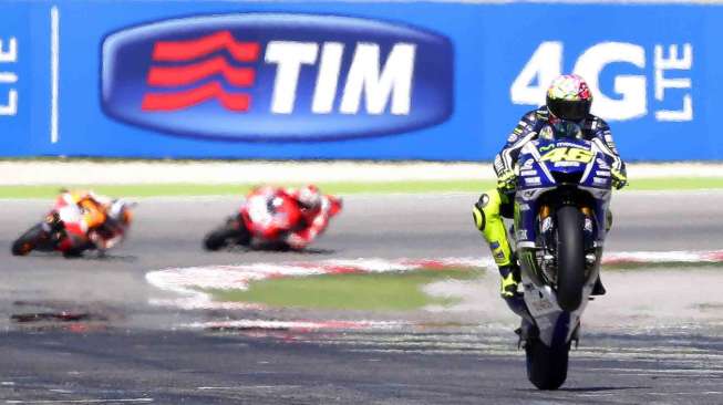 Valentino Rossi usai melewati garis finish di MotoGP San Marino Grand di Sirkuit Misano Adriatico, Italia, Minggu (14/9). [Reuters/Max Rossi]