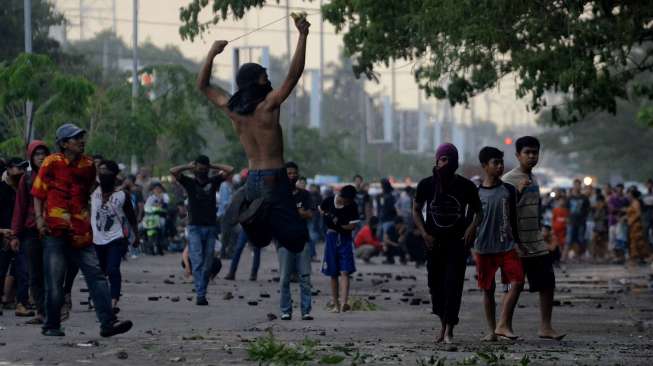 Sejumlah mahasiswa Universitas Muslim Indonesia (UMI) melempar batu dalam demo menolak kenaikan harga BBM di Makassar, Senin (17/11). [Sahrul Manda Tikupadang]