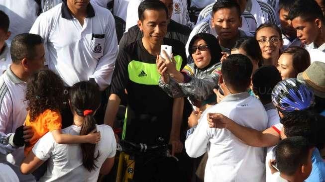 Presiden Joko Widodo bersepeda di ajang Car Free Day, kawasan Bundaran HI, Jakarta, (11/1). (Suara.com/Oke Atmaja)