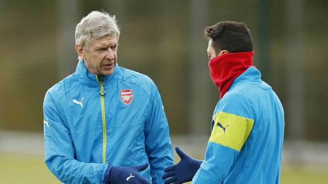 Manajer Arsenal Arsene Wenger berbicara dengan Mesut Ozil saat latihan di kompleks latihan The Gunners. Reuters/John Sibley Livepi