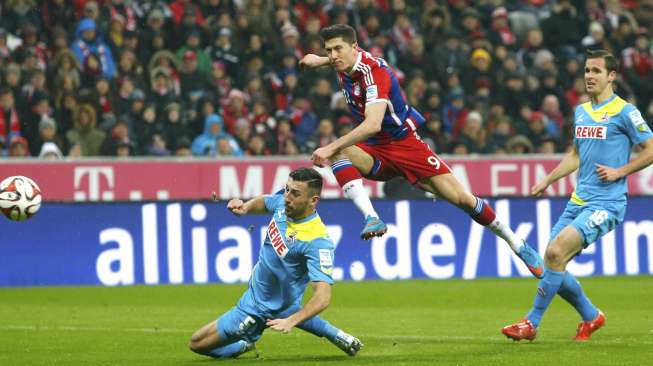 Pemain Bayern Munich Robert Lewandowski mencetak gol ke gawang FC Cologne. REUTERS/Michaela Rehle