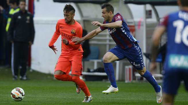 Pemain Barcelona Neymar (kiri) mengejar bola dan coba dihalangi pemain Eibar Borja Ekiza (15/3). REUTERS/Vincent West