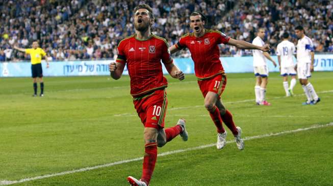 Pemain Wales Aaron Ramsey (kiri) merayakan golnya ke gawang Israel memanfatkan umpan Gareth Bale. REUTERS/Nir Elias