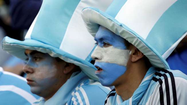 Dua Fans Argentina dengan topi yang unik menantikan Lionel Messi dan kawan kawan menghadapi Jamaika. Reuters/David Mercado