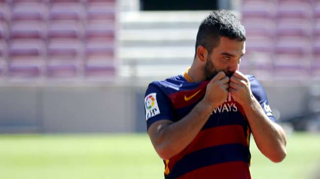 Pemain baru Barcelona Arda Turan saat diperkenalkan kepada publik di Camp Nou (10/7). Reuters/Gustau Nacarino