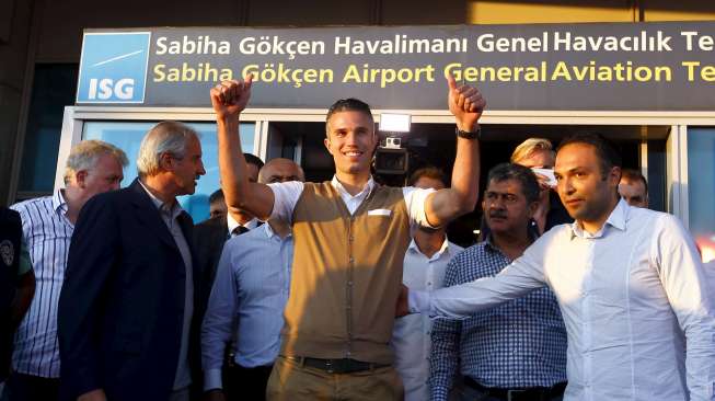 Robin van Persie menyapa para suporter Fenerbahce yang menyambutnya di bandara  Sabiha Gokcan, saat tiba di Istanbul, Turki (12/7). Reuters/Osman Orsal.