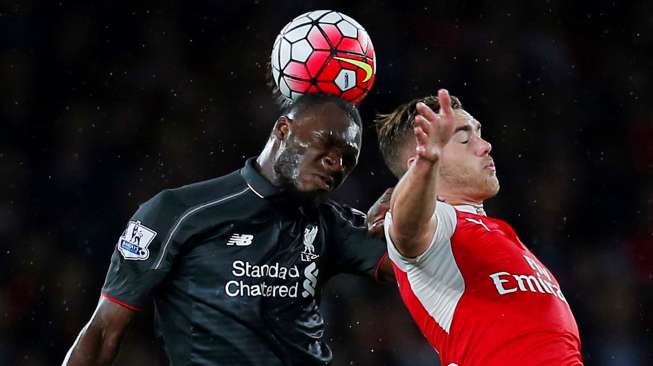 Pemain Arsenal Calum Chambers berebut bola dengan striker Liverpool Christian Benteke. Reuters / Eddie Keogh Livepic