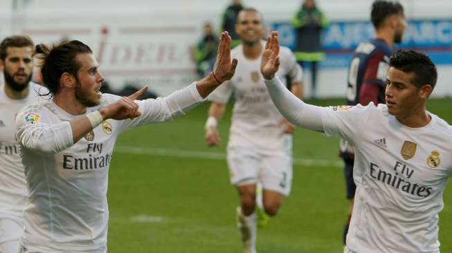 Gareth Bale melakukan selebrasi setelah mencetak gol pertama Real Madrid dengan James Rodriguez. Reuters/Joseba Etxaburu