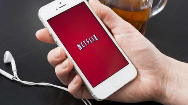 Ilustrasi menyaksikan tayangan Netflix melalui ponsel pintar (Shutterstock).