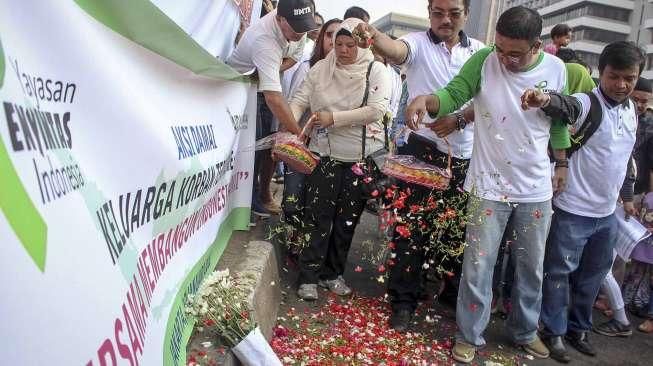 Sejumlah keluarga korban bom terorisme yang tergabung dalam Aliansi Indonesia Damai (AIDA) melakukan aksi tabur bunga di lokasi teror Jalan MH Thamrin, Jakarta, Minggu (17/1/2016). [Suara.com/Kurniawan Mas'ud]