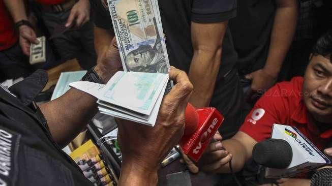 Ditemukan di dalam tas koper beserta cairan tinta alat pembersih uang dolar palsu.