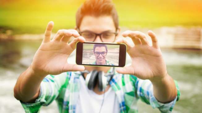 Ilustrasi pria mengambil gambar selfie (Shutterstock)