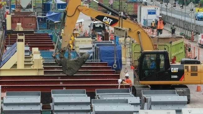 Pekerja menyelesaikan pembangunan infrastruktur Mass Rapid Transit (MRT) di kawasan Bunderan Hotel Indonesia (HI), Jakarta, Sabtu (19/3/2016). [Suara.com/Oke Atmaja]