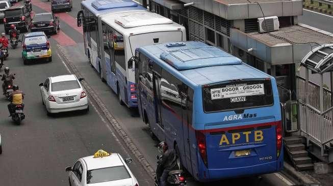 Angkutan Perbatasan Terintegrasi Bus Transjakarta (APTB) saat melintas di jalur busway di kawasan Gatot Soebroto, Jakarta, Senin (23/5). [suara.com/Kurniawan Mas'ud]