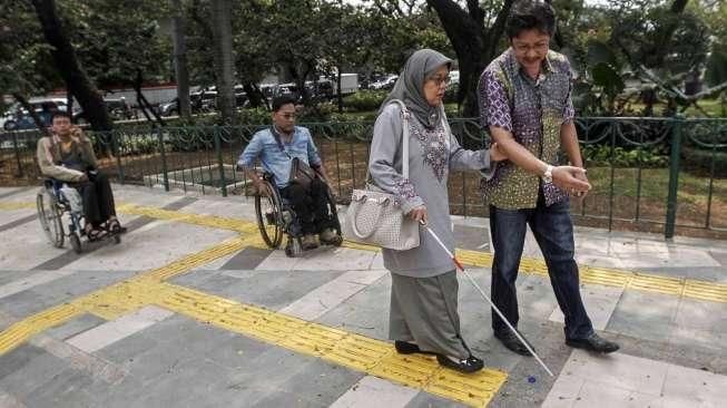 Sejumlah penyandang disabilitas dari Gerakan Aksesbilitas Umum Nasional (GAUN) DKI melakukan uji coba penggunaan trotoar ramah disabilitas di kawasan Jati Baru, Jakarta, Jumat (5/8).[Suara.com/Kurniawan Mas'ud]