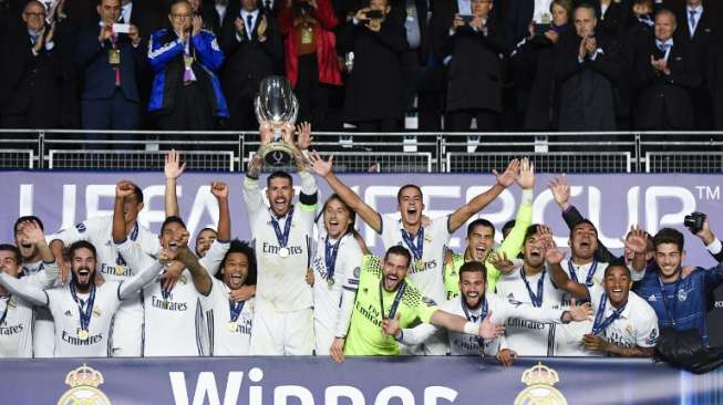 Pemain Real Madrid merayakan meraih trofi Piala Super Eropa setelah mengalahkan Sevilla. JONATHAN NACKSTRAND / AFP