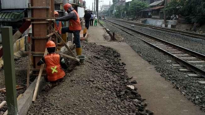 Aktivitas pekerja saat mengerjakan proyek pembuatan pagar sterilisasi Stasiun Tebet, Jakarta, Selasa (30/8/2016). [Suara.com/Oke Atmaja]