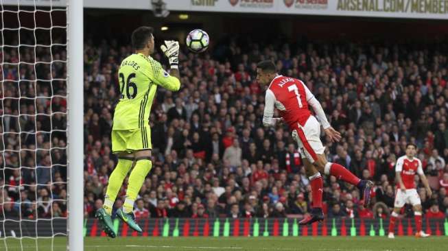 Sundulan pemain Arsenal Alexis Sanchez digagalkan kiper Víctor Valdes. Ian Kington / AFP